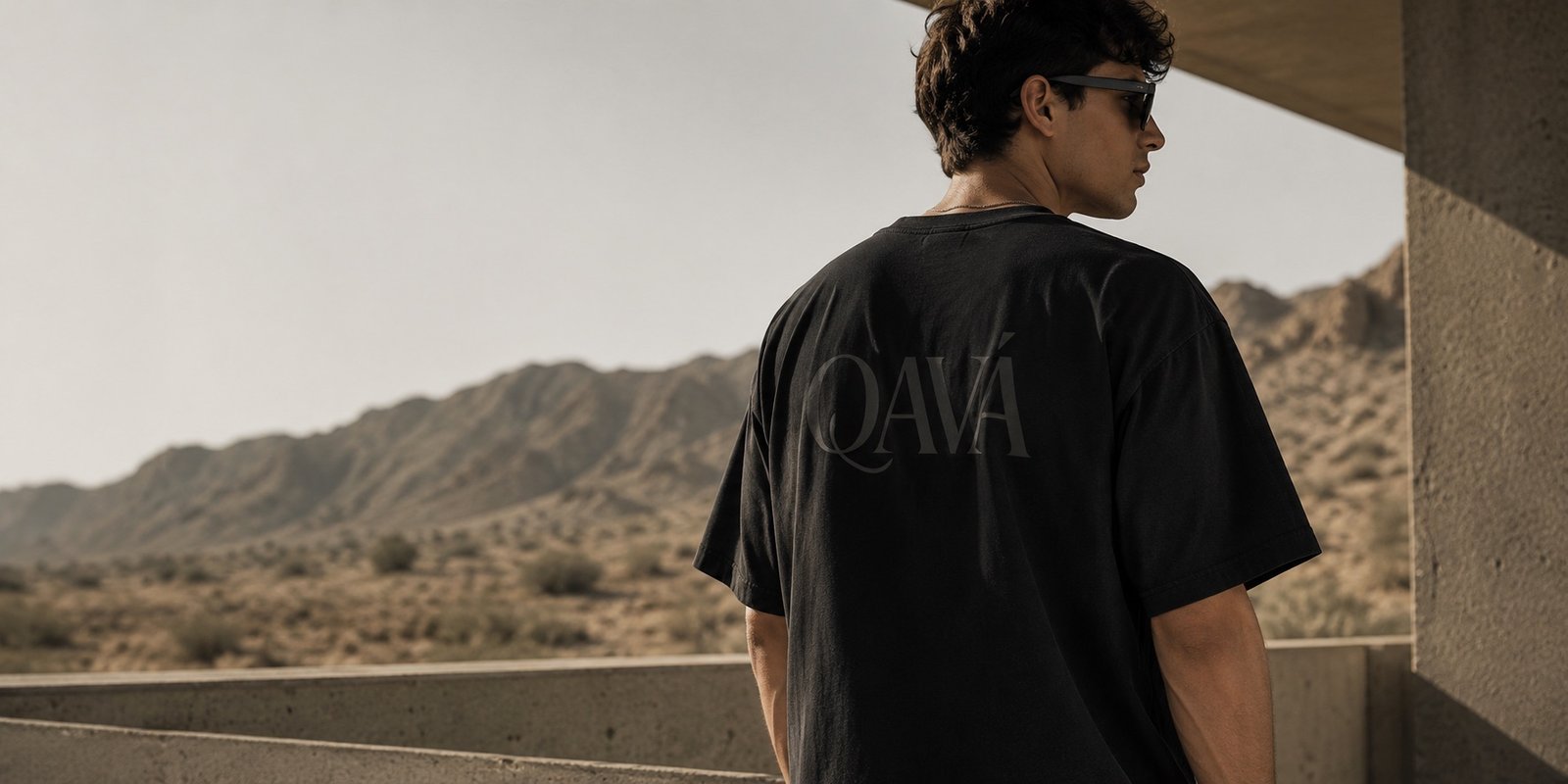 QAVÁ black T-shirt photographed in the desert