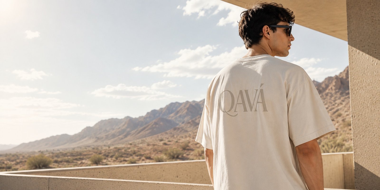 QAVÁ T-shirt photographed against a desert landscape